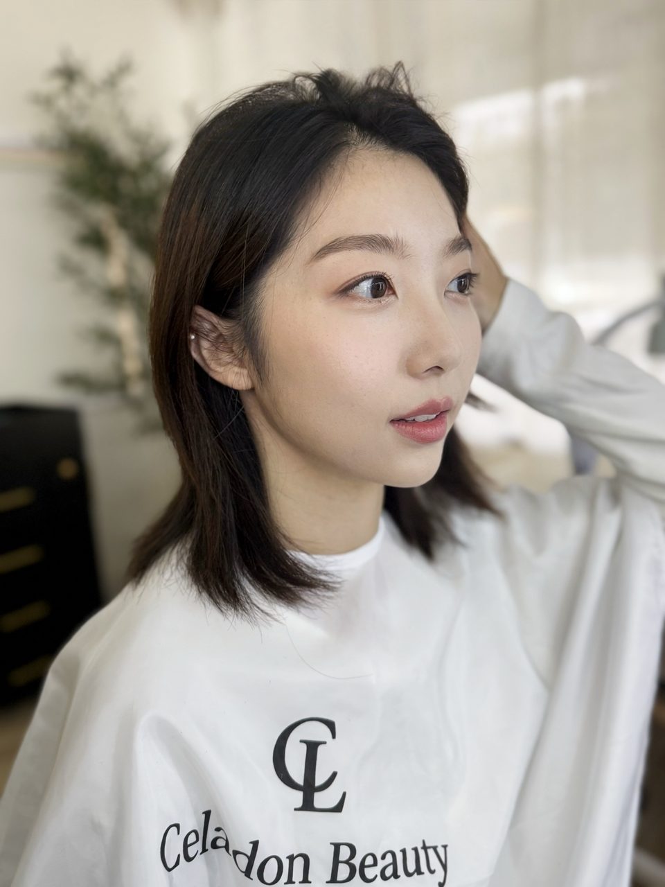 Profile showing dewy skin and soft eye makeup