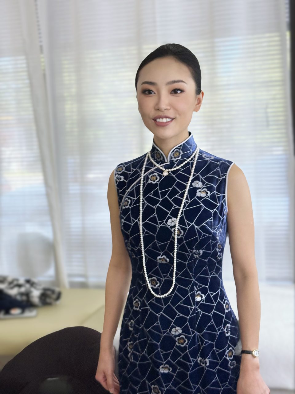 Full-length portrait in a qipao with pearls
