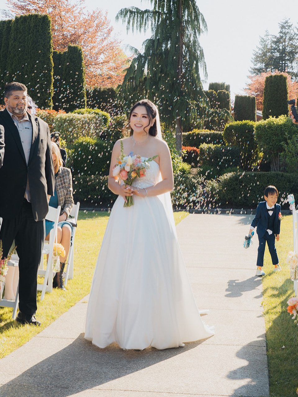 Bride walking down a garden aisle